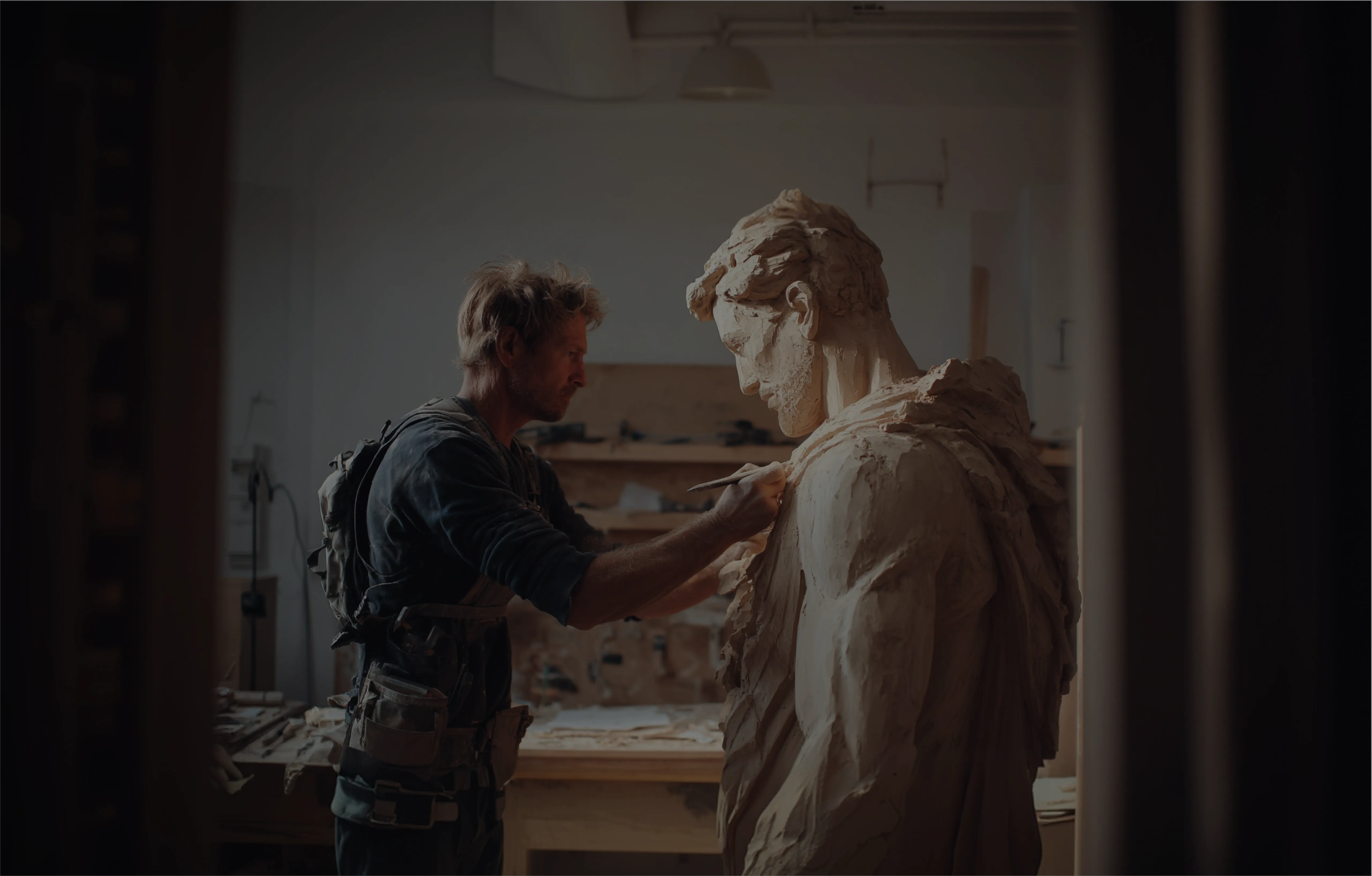 Sculptor carving a human statue mid-process – a visual metaphor for custom software MVP development.